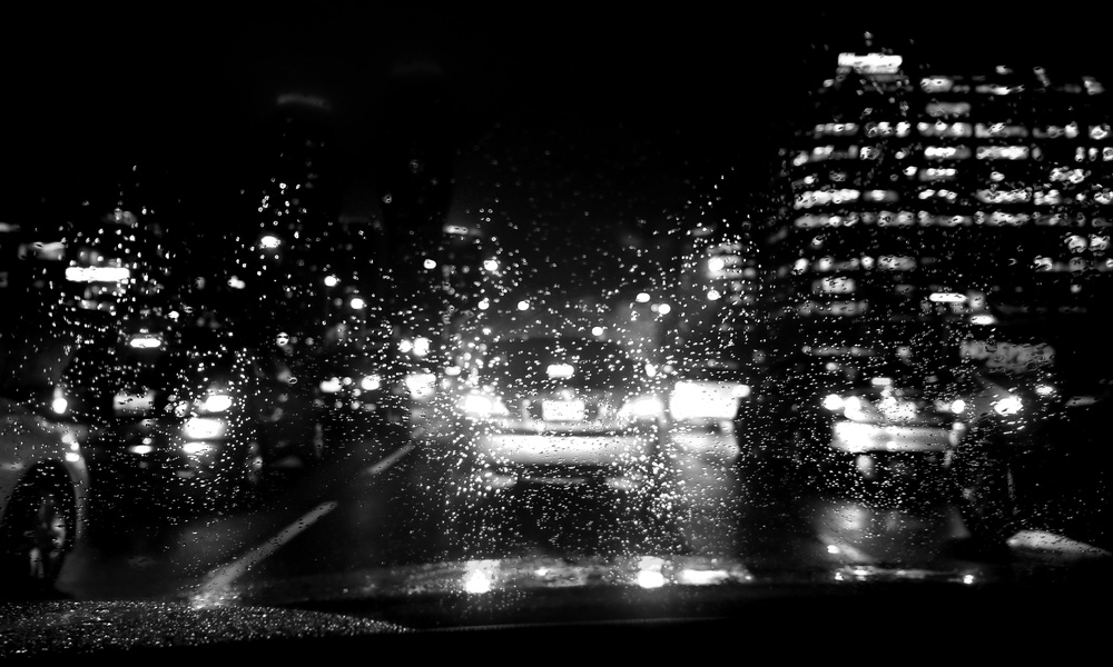 Cars behind rainy window