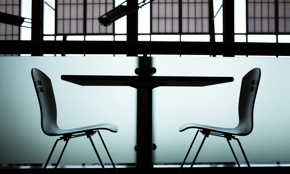 Two contraposed chairs at a small table